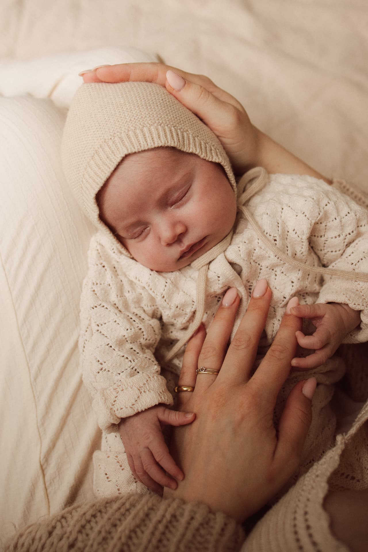 Zus geeft haar pasgeboren broertje of zusje een kus tijdens de newbornshoot